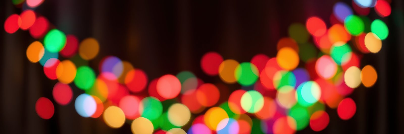 Colorful string lights create a festive atmosphere during a cozy indoor gathering in the evening